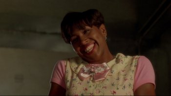 A woman smiling for the camera in a floral dress
