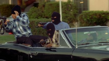 A group of people in a car with a gun