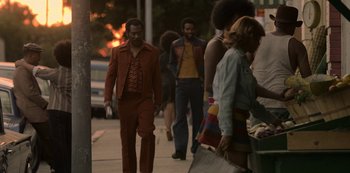 Movie still from “Dolemite Is My Name” (2019), directed by Craig Brewer – A group of people walking down a sidewalk; Wide shot, Low angle