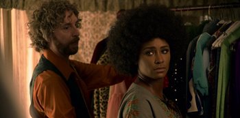 Movie still from “Dolemite Is My Name” (2019), directed by Craig Brewer – A woman with a large afro stands in front of a man with curly hair; Close Up shot, Over the shoulder angle