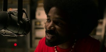 Movie still from “Dolemite Is My Name” (2019), directed by Craig Brewer – A person with a beard; Close Up shot, Over the shoulder angle