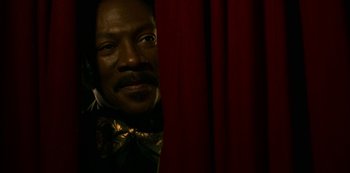 Movie still from “Dolemite Is My Name” (2019), directed by Craig Brewer – A black man with a mustache is looking at the camera; Close Up shot, Low angle
