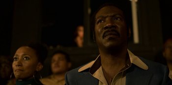 Movie still from “Dolemite Is My Name” (2019), directed by Craig Brewer – A person looking up at something; Close Up shot, Low angle
