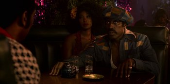 Movie still from “Dolemite Is My Name” (2019), directed by Craig Brewer – A man and a woman sitting at a table; Medium shot, Low angle