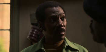 Movie still from “Dolemite Is My Name” (2019), directed by Craig Brewer – A person holding a cell phone; Close Up shot, Low angle