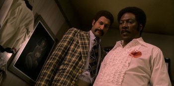 Movie still from “Dolemite Is My Name” (2019), directed by Craig Brewer – Two men standing next to each other in a room; Medium shot, Low angle