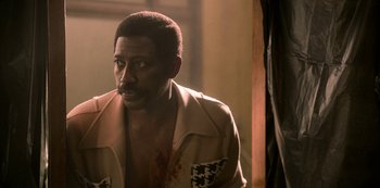 Movie still from “Dolemite Is My Name” (2019), directed by Craig Brewer – A man in a tan jacket looking at the camera; Close Up shot, Over the shoulder angle