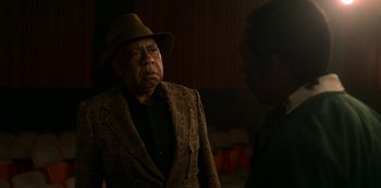 Movie still from “Dolemite Is My Name” (2019), directed by Craig Brewer – An older man wearing a hat and a suit; Medium shot, Over the shoulder angle