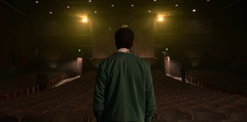 Movie still from “Dolemite Is My Name” (2019), directed by Craig Brewer – A man standing in front of an empty auditorium; Medium shot, Low angle