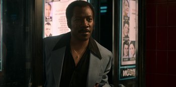 Movie still from “Dolemite Is My Name” (2019), directed by Craig Brewer – A black man in a suit and a necklace; Close Up shot, Low angle