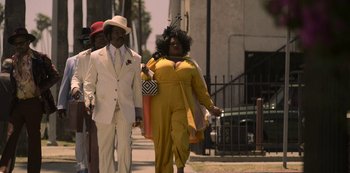 Movie still from “Dolemite Is My Name” (2019), directed by Craig Brewer – A man and a woman walking down a street; Wide shot, Low angle