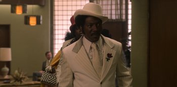 Movie still from “Dolemite Is My Name” (2019), directed by Craig Brewer – A man in a white suit and a white hat; Medium shot, Low angle