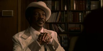Movie still from “Dolemite Is My Name” (2019), directed by Craig Brewer – A man in a white hat and a tie; Close Up shot, Low angle