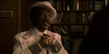Movie still from “Dolemite Is My Name” (2019), directed by Craig Brewer – A man in a white suit and a white cowboy hat; Close Up shot, High angle