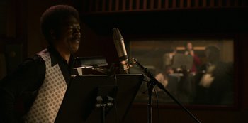 Movie still from “Dolemite Is My Name” (2019), directed by Craig Brewer – A man is standing in front of a microphone; Close Up shot, Low angle