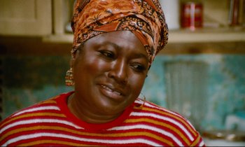 Movie still from “Don't Play Us Cheap” (1972), directed by Melvin Van Peebles – A person wearing a head scarf; Close Up shot, High angle