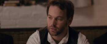 Movie still from “Don't Think Twice” (2016), directed by Mike Birbiglia – A person wearing a vest; Close Up shot, Over the shoulder angle
