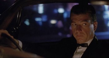 Movie still from “Double Impact” (1991), directed by Sheldon Lettich – A person sitting in a car at night; Close Up shot, Over the shoulder angle