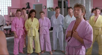 Movie still from “Double Impact” (1991), directed by Sheldon Lettich – A group of people standing next to each other in robes; Medium shot, Low angle