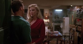 Movie still from “Double Impact” (1991), directed by Sheldon Lettich – A man and a woman standing in front of each other; Medium shot, Over the shoulder angle