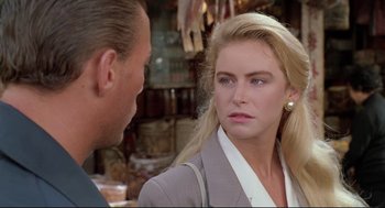 Movie still from “Double Impact” (1991), directed by Sheldon Lettich – A man and a woman talking to each other; Close Up shot, Over the shoulder angle