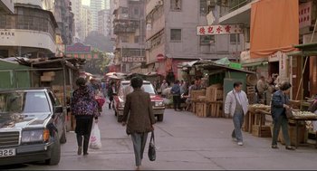 Movie still from “Double Impact” (1991), directed by Sheldon Lettich – A group of people walking down a street; Extreme Wide shot, High angle