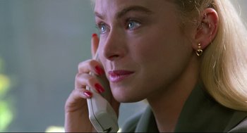 Movie still from “Double Impact” (1991), directed by Sheldon Lettich – A person talking on a cell phone; Close Up shot, Low angle