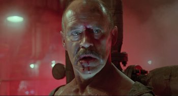 Movie still from “Double Impact” (1991), directed by Sheldon Lettich – A person with blood on his face; Close Up shot, Low angle