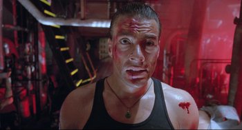 Movie still from “Double Impact” (1991), directed by Sheldon Lettich – A person with blood all over his face; Close Up shot, Low angle