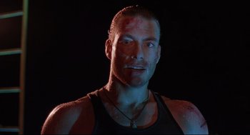 Movie still from “Double Impact” (1991), directed by Sheldon Lettich – A person wearing a black shirt; Close Up shot, Low angle