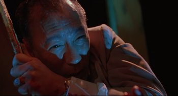 Movie still from “Double Impact” (1991), directed by Sheldon Lettich – An older man is holding a piece of paper; Close Up shot, Low angle