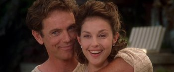 Movie still from “Double Jeopardy” (1999), directed by Bruce Beresford – Two people smiling for the camera; Close Up shot, Low angle