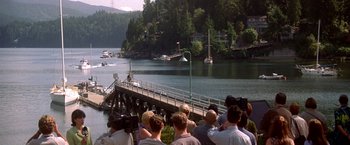 Movie still from “Double Jeopardy” (1999), directed by Bruce Beresford – A group of people standing on a dock watching boats; Extreme Wide shot, High angle