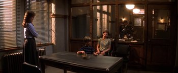 Movie still from “Double Jeopardy” (1999), directed by Bruce Beresford – Two people sitting at a table with a bowl of food; Wide shot, High angle