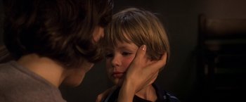 Movie still from “Double Jeopardy” (1999), directed by Bruce Beresford – A young boy with his hand on his ear; Close Up shot, Over the shoulder angle