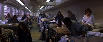 Movie still from “Double Jeopardy” (1999), directed by Bruce Beresford – A group of people sitting on top of a bed; Wide shot, High angle