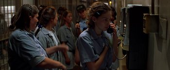 Movie still from “Double Jeopardy” (1999), directed by Bruce Beresford – A group of people standing in a room; Medium shot, Over the shoulder angle