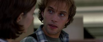 Movie still from “Double Jeopardy” (1999), directed by Bruce Beresford – A young man with blue eyes stares at a young woman; Close Up shot, Over the shoulder angle