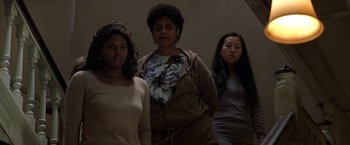 Movie still from “Double Jeopardy” (1999), directed by Bruce Beresford – A group of women standing next to each other in a room; Medium shot, Low angle