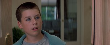 Movie still from “Double Jeopardy” (1999), directed by Bruce Beresford – A young boy with blue eyes looking at the camera; Close Up shot, Low angle