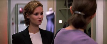Movie still from “Double Jeopardy” (1999), directed by Bruce Beresford – A woman wearing a suit talking to another woman in front of a mirror; Close Up shot, Over the shoulder angle