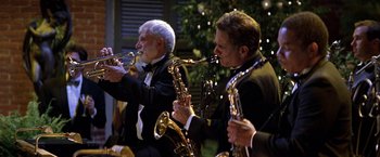 Movie still from “Double Jeopardy” (1999), directed by Bruce Beresford – A group of men in tuxedos playing musical instruments; Medium shot, Low angle