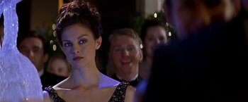 Movie still from “Double Jeopardy” (1999), directed by Bruce Beresford – A group of people standing in a room at a party; Close Up shot, Over the shoulder angle