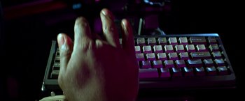 Movie still from “Double Jeopardy” (1999), directed by Bruce Beresford – A person's hand on a computer keyboard; Extreme Close Up shot, High angle