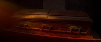 Movie still from “Double Jeopardy” (1999), directed by Bruce Beresford – An open casket in a dark room lit by a lamp; Extreme Close Up shot, High angle