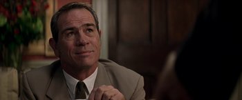 Movie still from “Double Jeopardy” (1999), directed by Bruce Beresford – A person wearing a suit and tie; Close Up shot, Over the shoulder angle