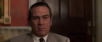 Movie still from “Double Jeopardy” (1999), directed by Bruce Beresford – A person wearing a suit and tie; Close Up shot, Over the shoulder angle