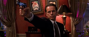 Movie still from “Double Jeopardy” (1999), directed by Bruce Beresford – A man in a suit and tie holding a cell phone; Close Up shot, Low angle