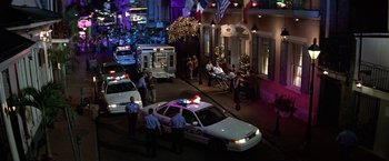 Movie still from “Double Jeopardy” (1999), directed by Bruce Beresford – A police car parked on the side of the street; Extreme Wide shot, High angle