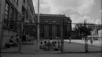 Movie still from “Down by Law” (1986), directed by Jim Jarmusch – A group of kids playing a game on a court; Extreme Wide shot, High angle